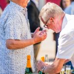 People at an outdoor drinks bar.