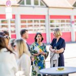 People chatting at an outdoor reception.