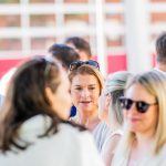 People chatting outside in the sunshine.