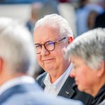 Elderly man with glasses at event