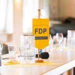FDP logo on yellow table banner