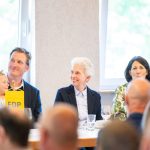 People at an FDP event, smiling.