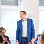 Person in blue suit at meeting