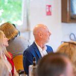 People in conversation at a formal event