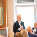 Person gives speech at meeting