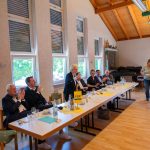 FDP members at a meeting in a conference room.