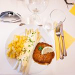 Asparagus with schnitzel and potatoes on a plate